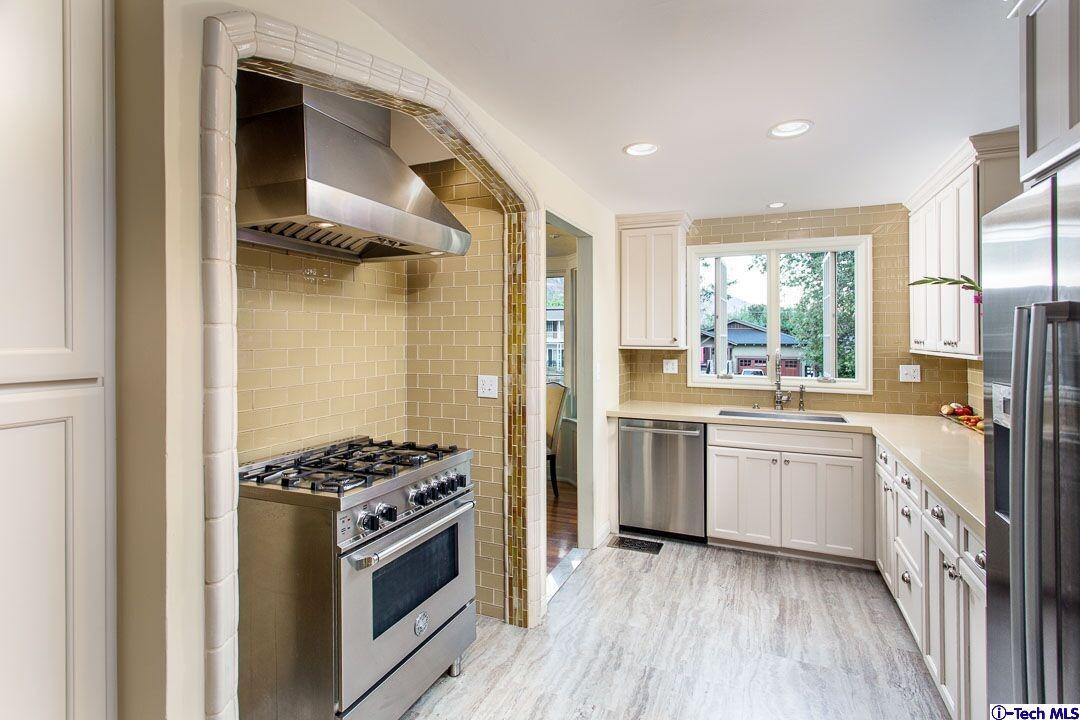 1911 Pepper Drive Altadena, CA 91001 - Photo 11 of 28 a kitchen with a stove a sink and a refrigerator
