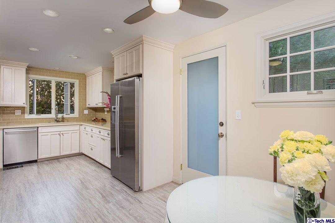 1911 Pepper Drive Altadena, CA 91001 - Photo 12 of 28 a kitchen with a refrigerator window and wooden floor