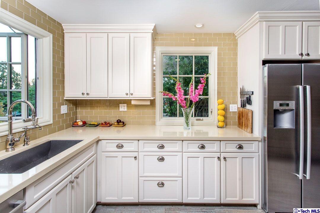 1911 Pepper Drive Altadena, CA 91001 - Photo 9 of 28 a kitchen with stainless steel appliances a white cabinets and a window