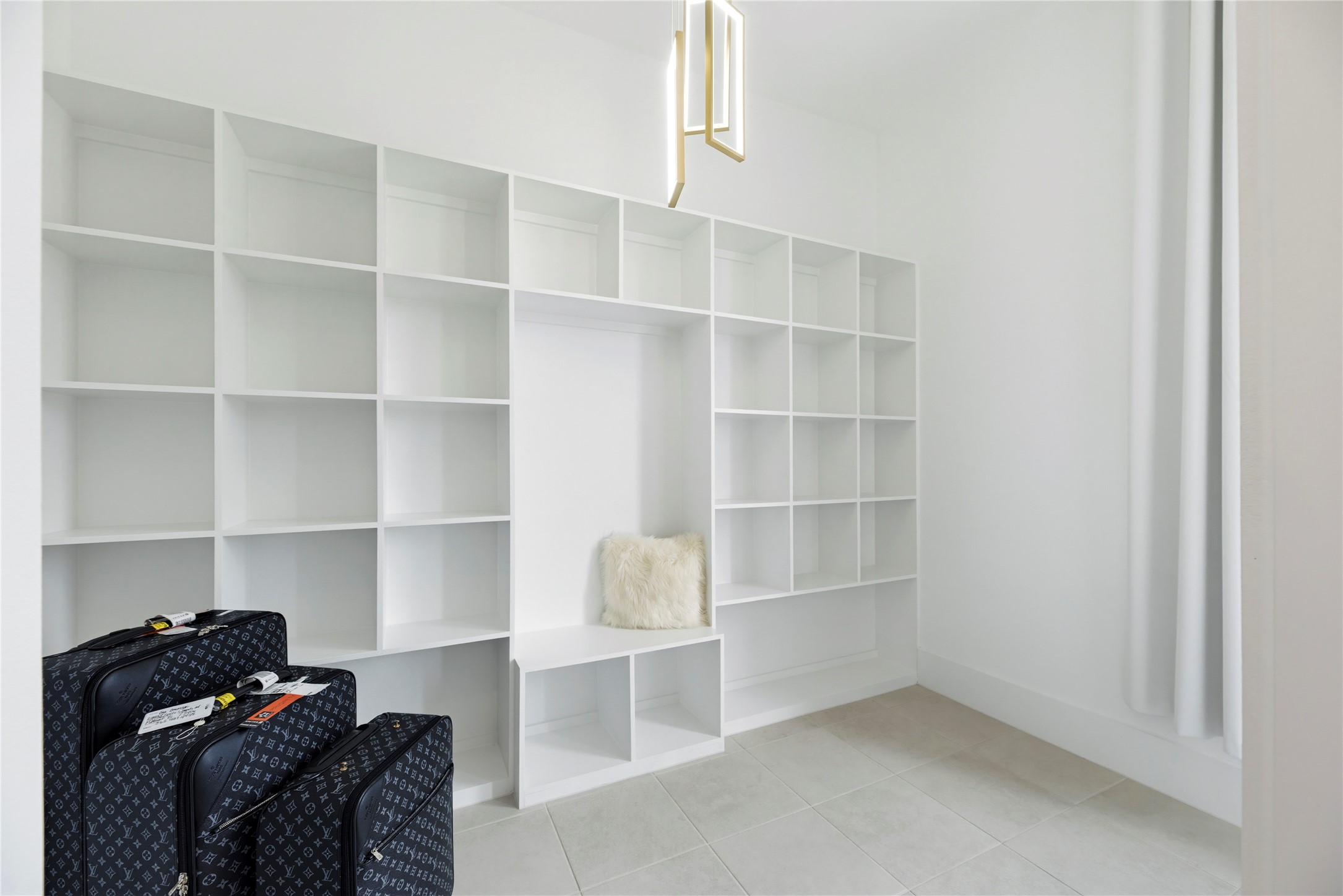 29526 Cir S Rnch Trail Fulshear, TX 77406 - Photo 22 of 47 The massive primary walk-in closet is an organizational dream, featuring extensive custom-built white cabinetry and multi-level shelving. Designer lighting and a clean, modern layout make this space as functional as it is beautiful.