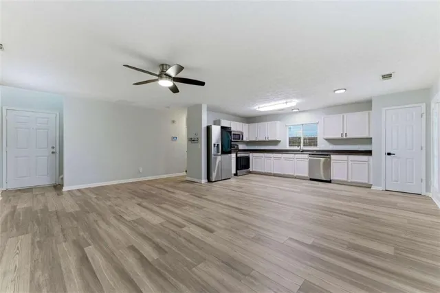 a view of a kitchen with a stove cabinets and wooden floor