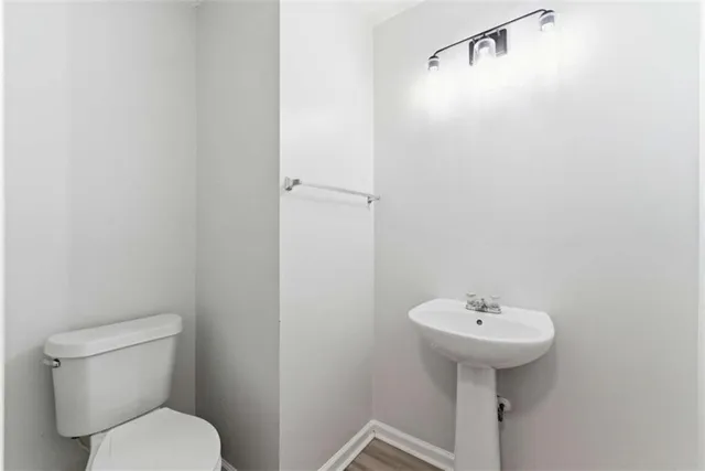 a bathroom with a sink toilet and a mirror