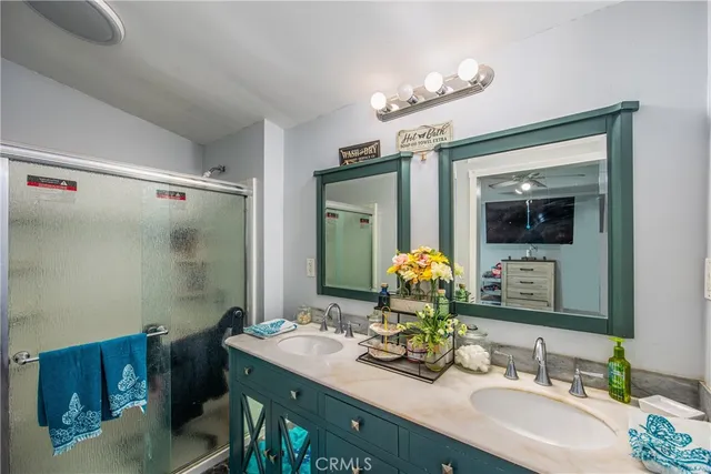 a bathroom with a double vanity sink and a mirror