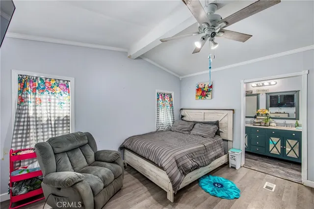 a bedroom with a bed couch and a window