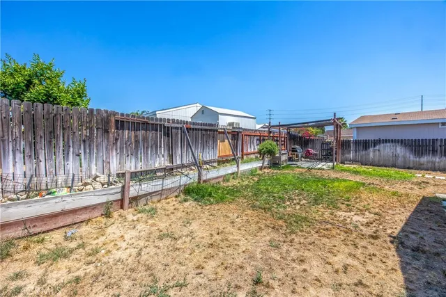 a view of a house with backyard and swimming pool