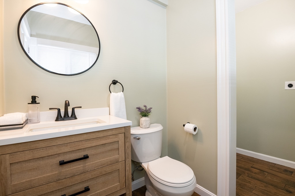 179 Lions Mouth Road Amesbury, MA 01913 - Photo 11 of 42 a bathroom with a toilet a sink and mirror