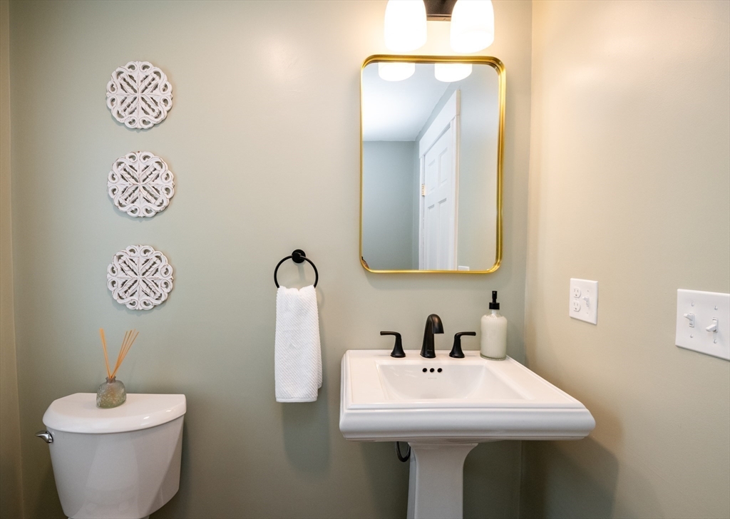 179 Lions Mouth Road Amesbury, MA 01913 - Photo 20 of 42 a bathroom with a toilet sink and mirror