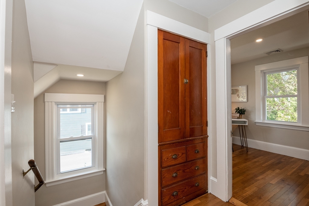 179 Lions Mouth Road Amesbury, MA 01913 - Photo 26 of 42 a view of a hallway with wooden floor and windows