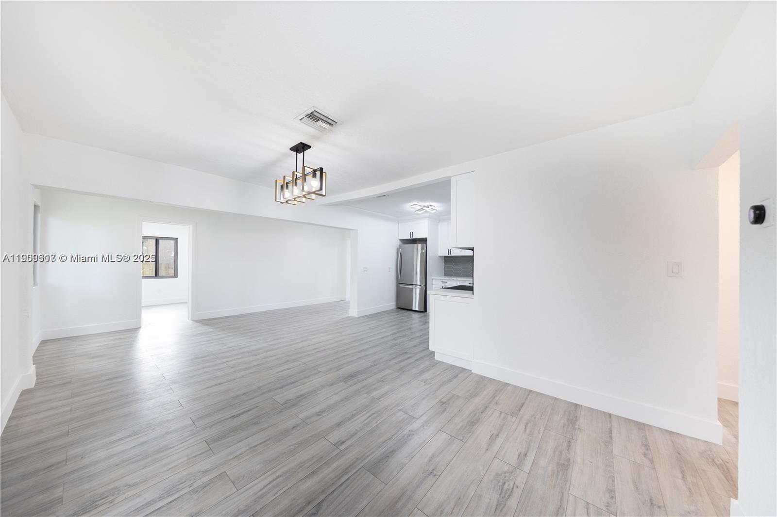 271 Northwest 143rd Street Miami, FL 33168 - Photo 14 of 43 a view of empty room with wooden floor and ceiling fan
