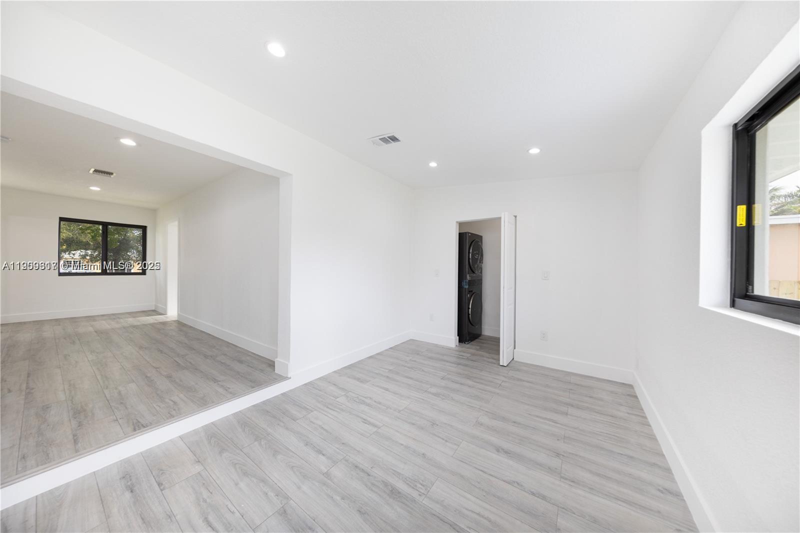 271 Northwest 143rd Street Miami, FL 33168 - Photo 15 of 43 wooden floor in an empty room with a window