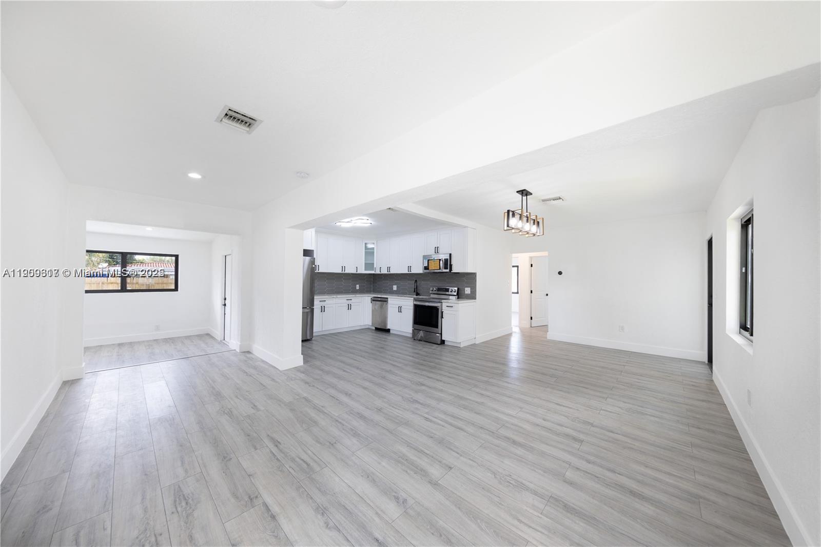 271 Northwest 143rd Street Miami, FL 33168 - Photo 16 of 43 a view of a kitchen with wooden floor and a kitchen