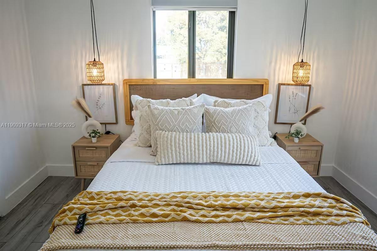 271 Northwest 143rd Street Miami, FL 33168 - Photo 19 of 43 a bedroom with a bed and wooden floor