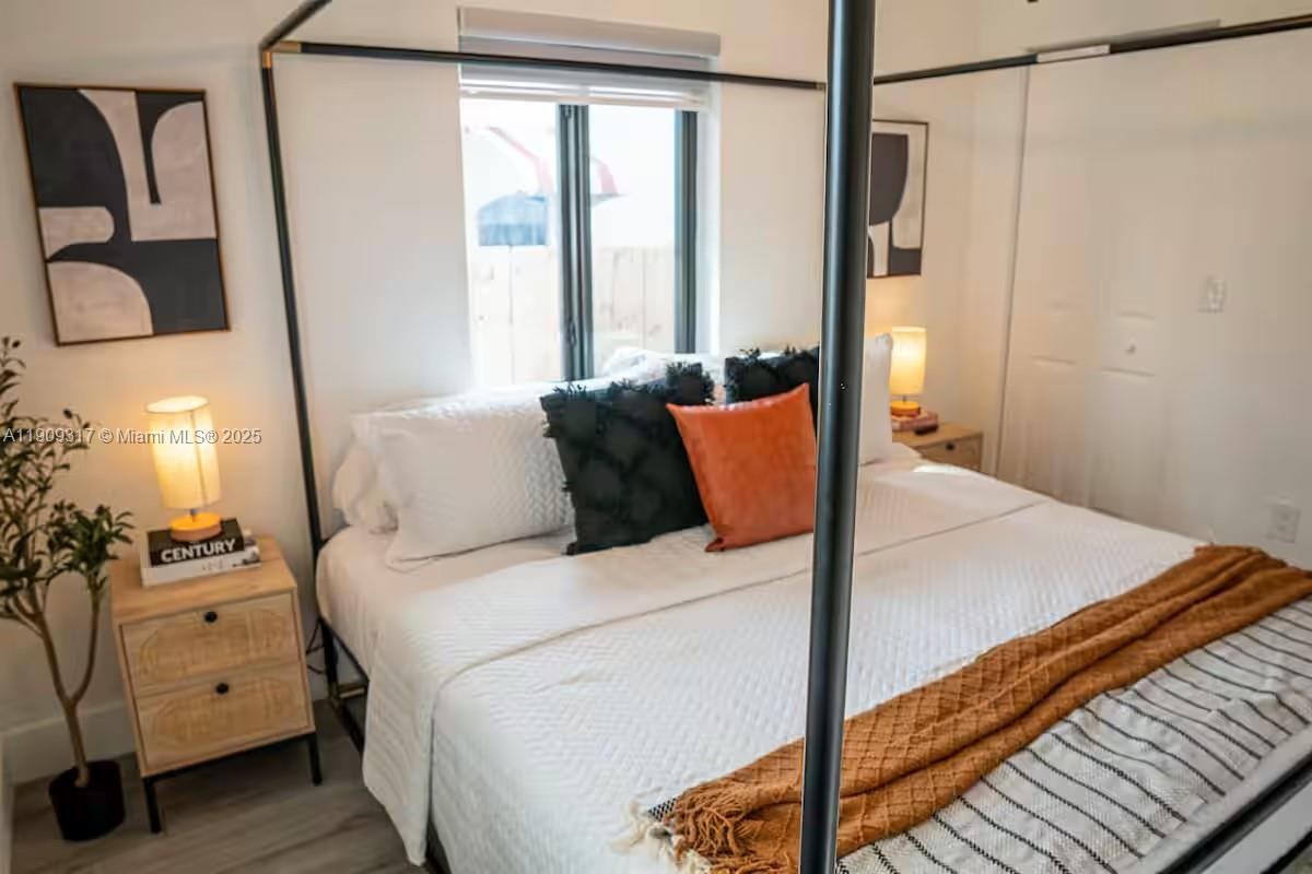 271 Northwest 143rd Street Miami, FL 33168 - Photo 26 of 43 a bedroom with a bed and a potted plant