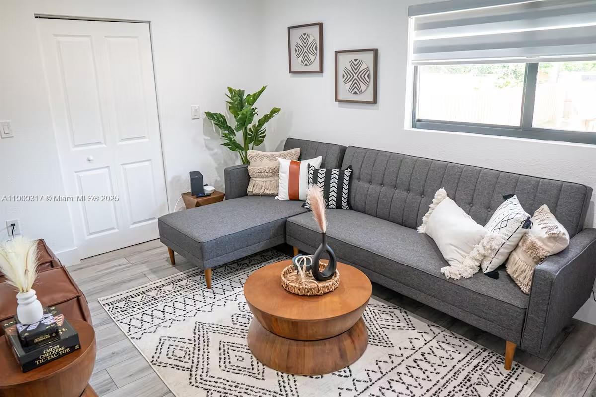 271 Northwest 143rd Street Miami, FL 33168 - Photo 3 of 43 a living room with furniture and a rug