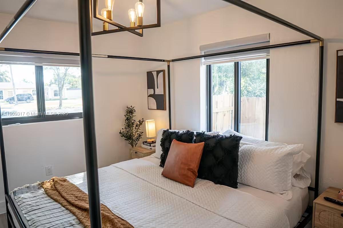 271 Northwest 143rd Street Miami, FL 33168 - Photo 33 of 43 a bed sitting in a bedroom next to a window