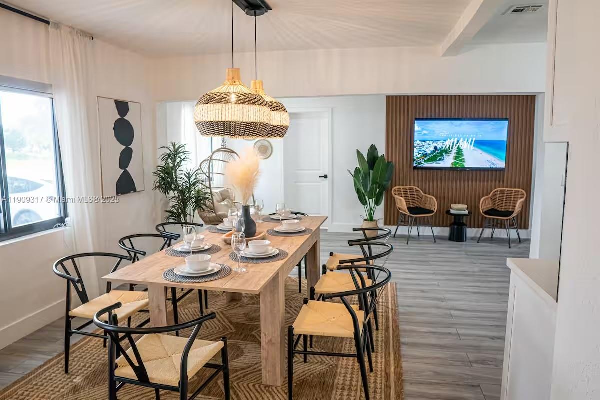 271 Northwest 143rd Street Miami, FL 33168 - Photo 7 of 43 a dining room with furniture and a chandelier