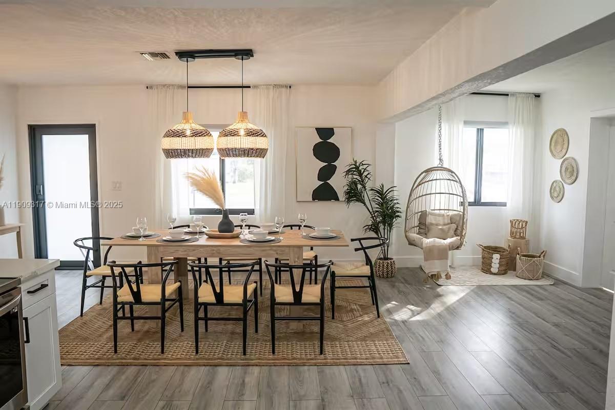271 Northwest 143rd Street Miami, FL 33168 - Photo 8 of 43 a view of a a dining room with furniture window and wooden floor