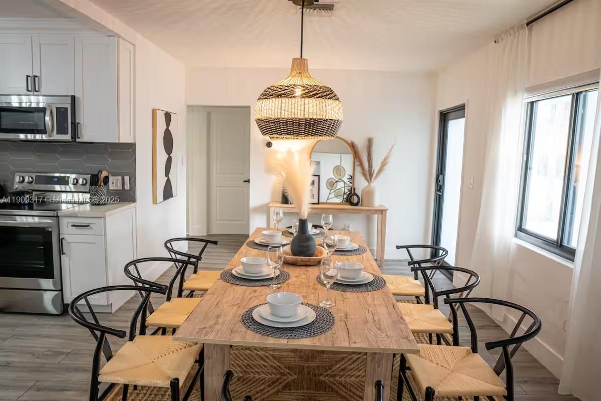271 Northwest 143rd Street Miami, FL 33168 - Photo 9 of 43 a table and chairs in a kitchen