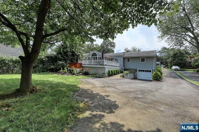 230 Pinelynn Road Glen Rock, NJ 07452 - Photo 18 of 19 a front view of a house with a yard and a large tree