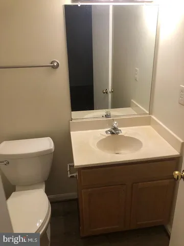 a bathroom with a sink toilet and mirror