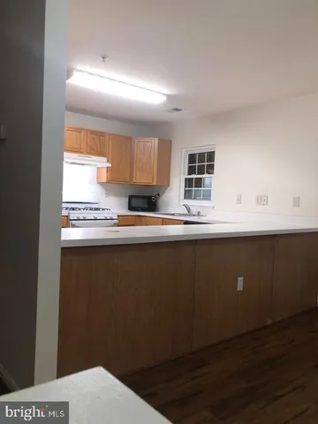 a kitchen with a sink a stove and cabinets