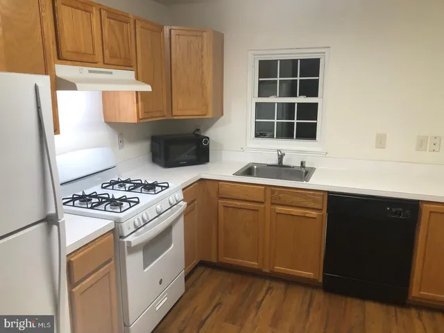 a kitchen with a stove a sink and a microwave