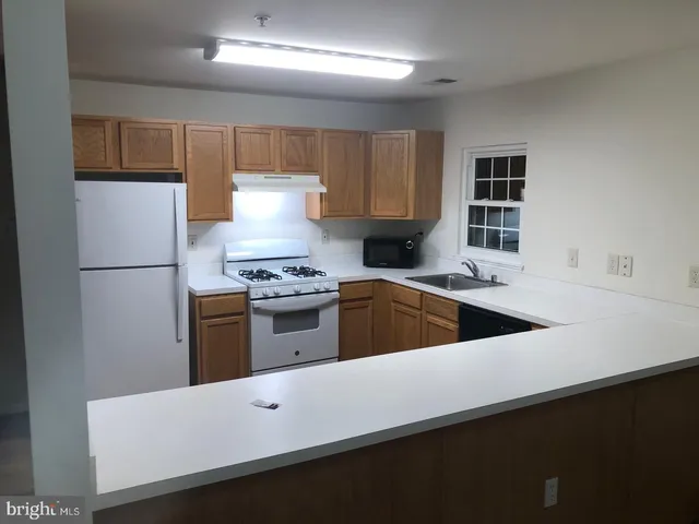 a kitchen with a white cabinets and white appliances