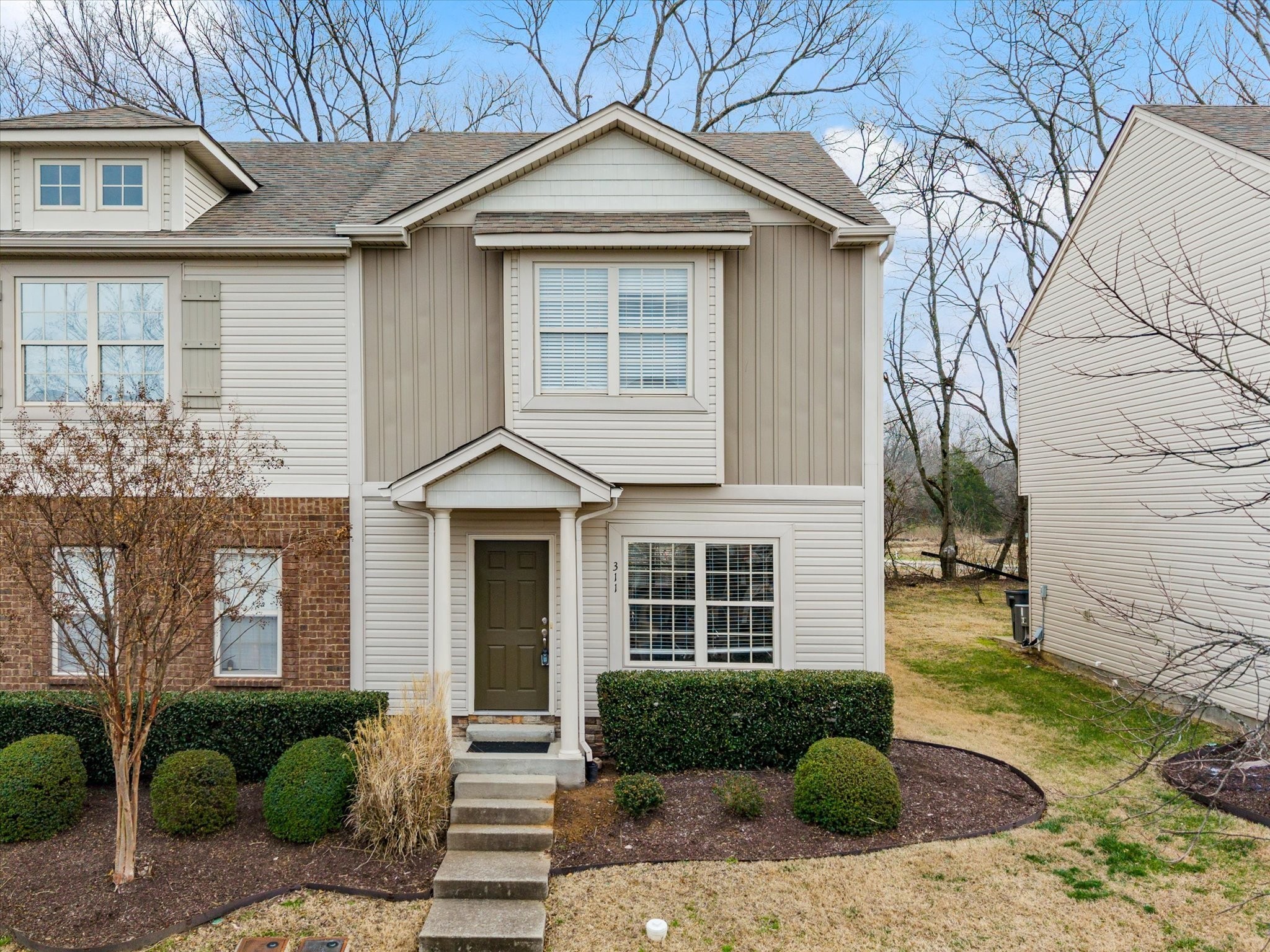 735 Tulip Grove Road, Unit 311 Hermitage, TN 37076 - Photo 1 of 22 a front view of a house with a yard and garage
