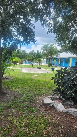 a view of outdoor space with garden and trees