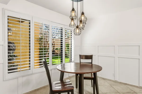 a view of a dining room with furniture and a window