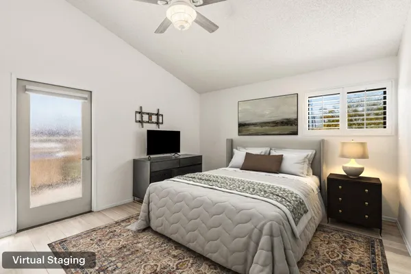 a bedroom with a bed and wooden floor