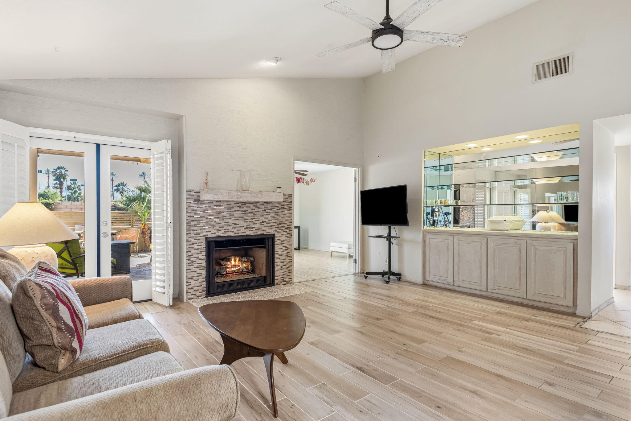 74171 Santa Rosa Circle Palm Desert, CA 92260 - Photo 5 of 32 a living room with furniture a flat screen tv and a fireplace