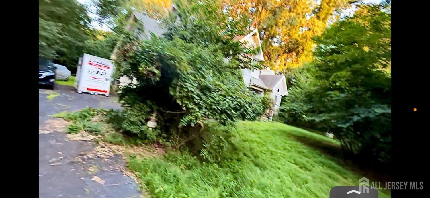 114 Greenwood Road Morganville, NJ 07751 - Photo 3 of 7 a sign that is sitting in the middle of a yard