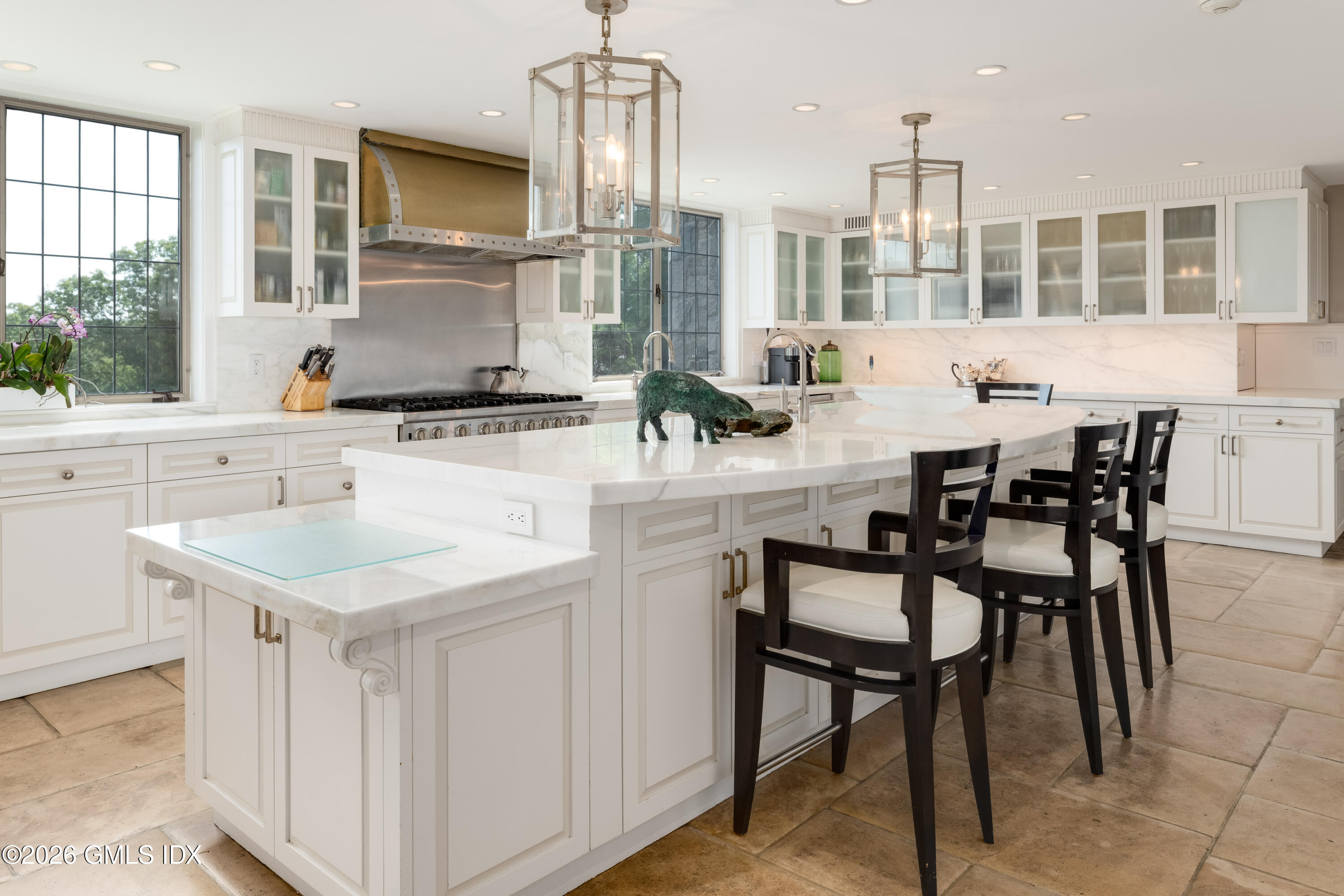 1233 Rock Rimmon Road Stamford, CT 06903 - Photo 11 of 50 a kitchen with a dining table chairs and white cabinets