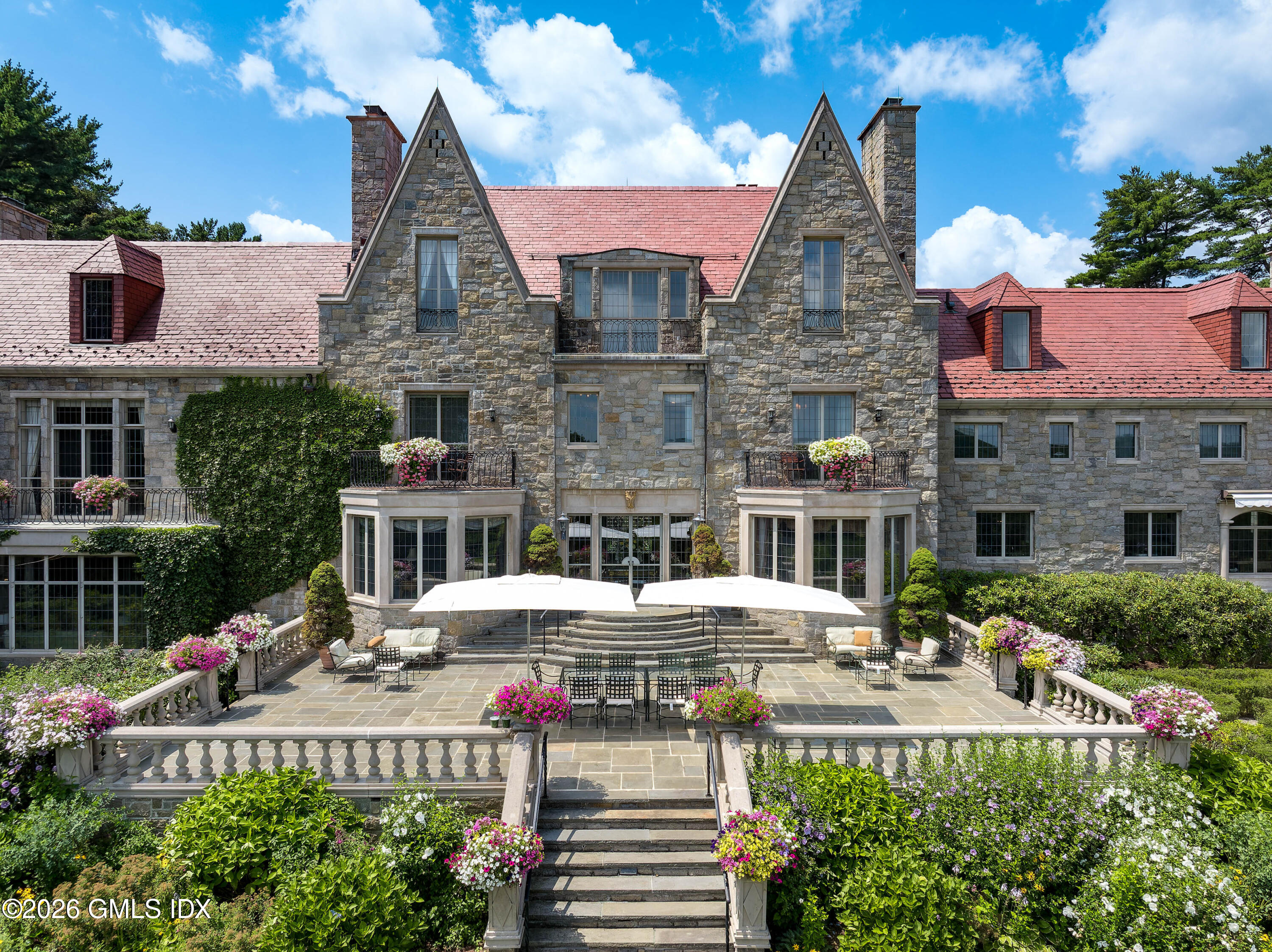 1233 Rock Rimmon Road Stamford, CT 06903 - Photo 24 of 50 a view of a patio with couches table and chairs and potted plants