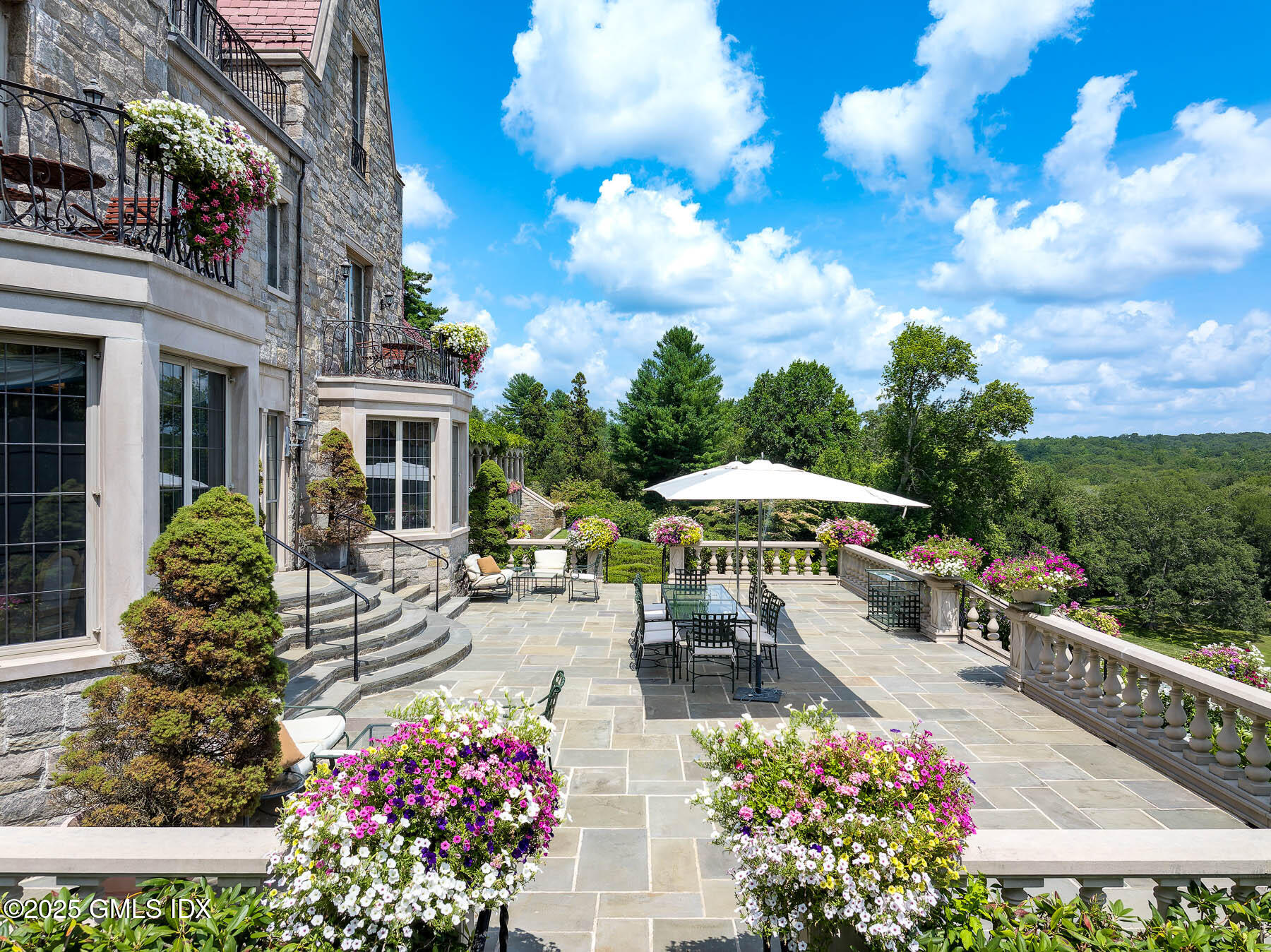 1233 Rock Rimmon Road Stamford, CT 06903 - Photo 25 of 50 a view of a patio with table and chairs potted plants