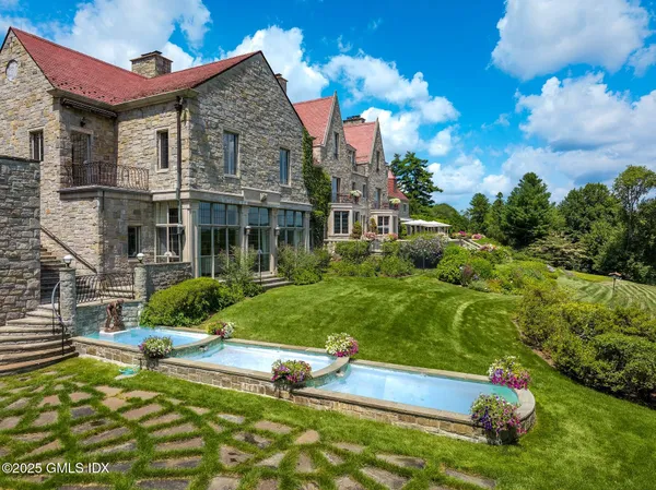 a aerial view of a house with swimming pool garden and patio