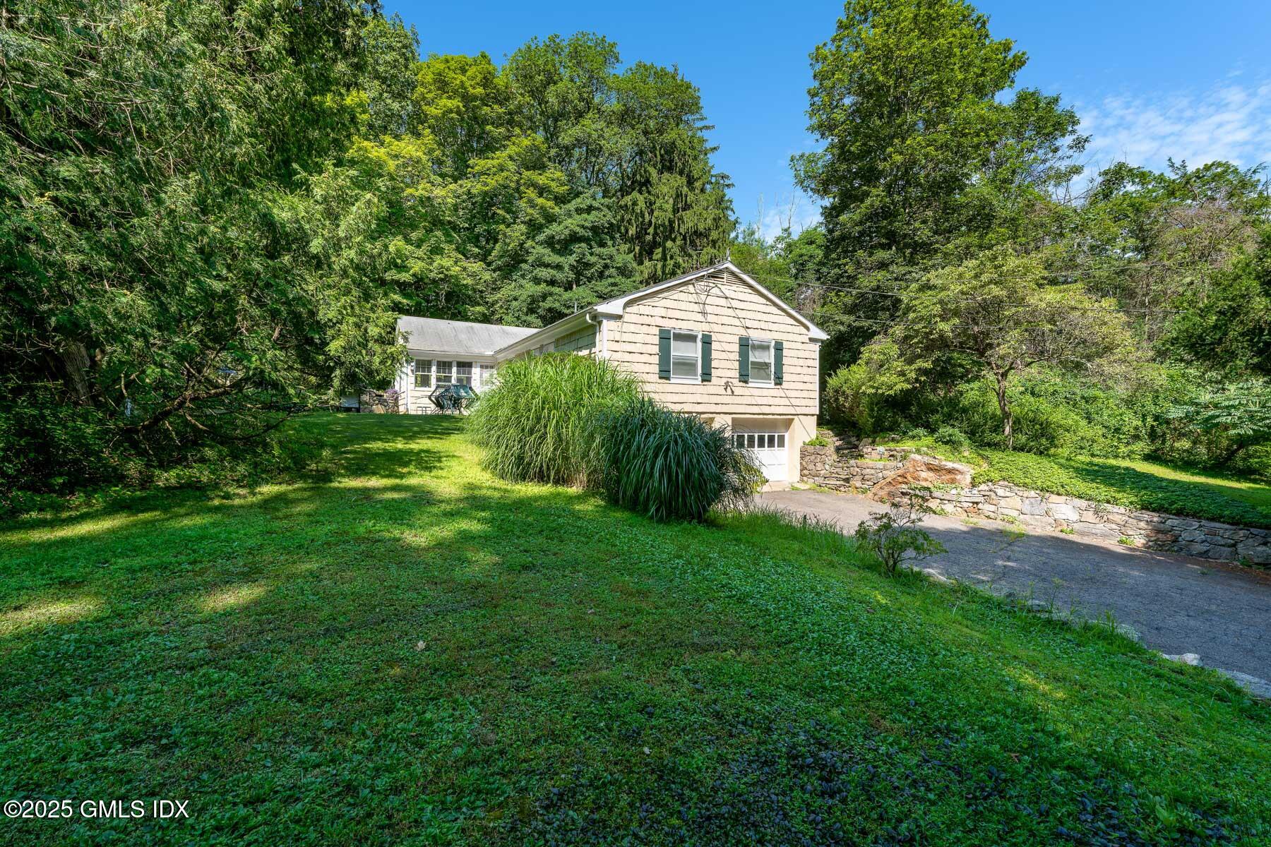 1233 Rock Rimmon Road Stamford, CT 06903 - Photo 49 of 50 a front view of a house with a yard