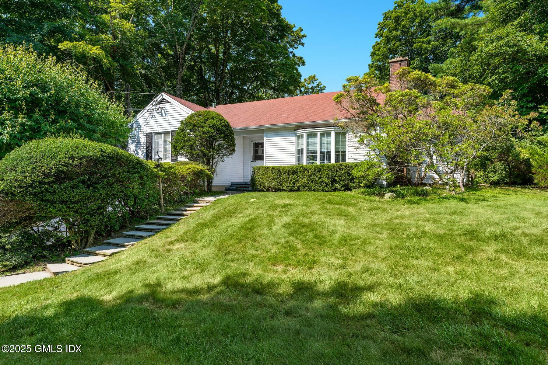1233 Rock Rimmon Road Stamford, CT 06903 - Photo 50 of 50 a front view of a house with garden