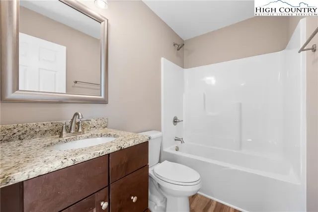 a bathroom with a sink a toilet and bathtub