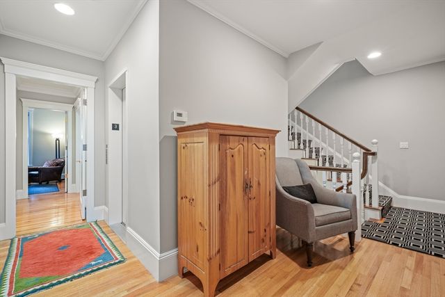 a view of a hallway with wooden floor and stairs