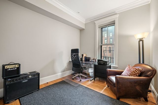 a livingroom with workspace and a couch
