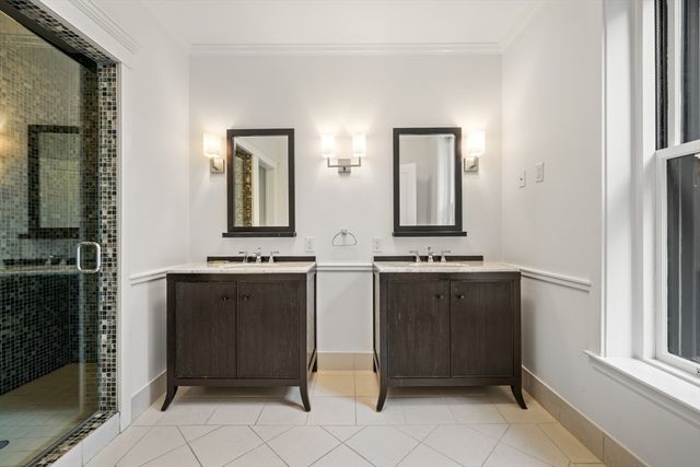 a bathroom with two mirror and a sink