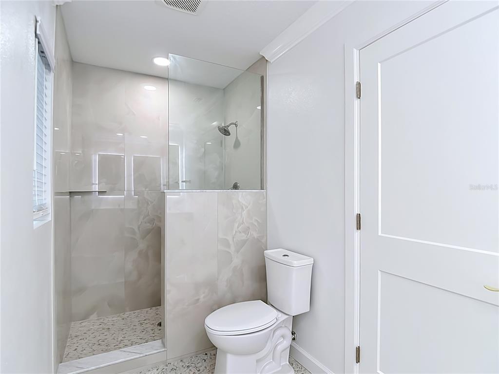 4536 Mitcher Road New Port Richey, FL 34652 - Photo 14 of 46 a bathroom with a toilet and a shower