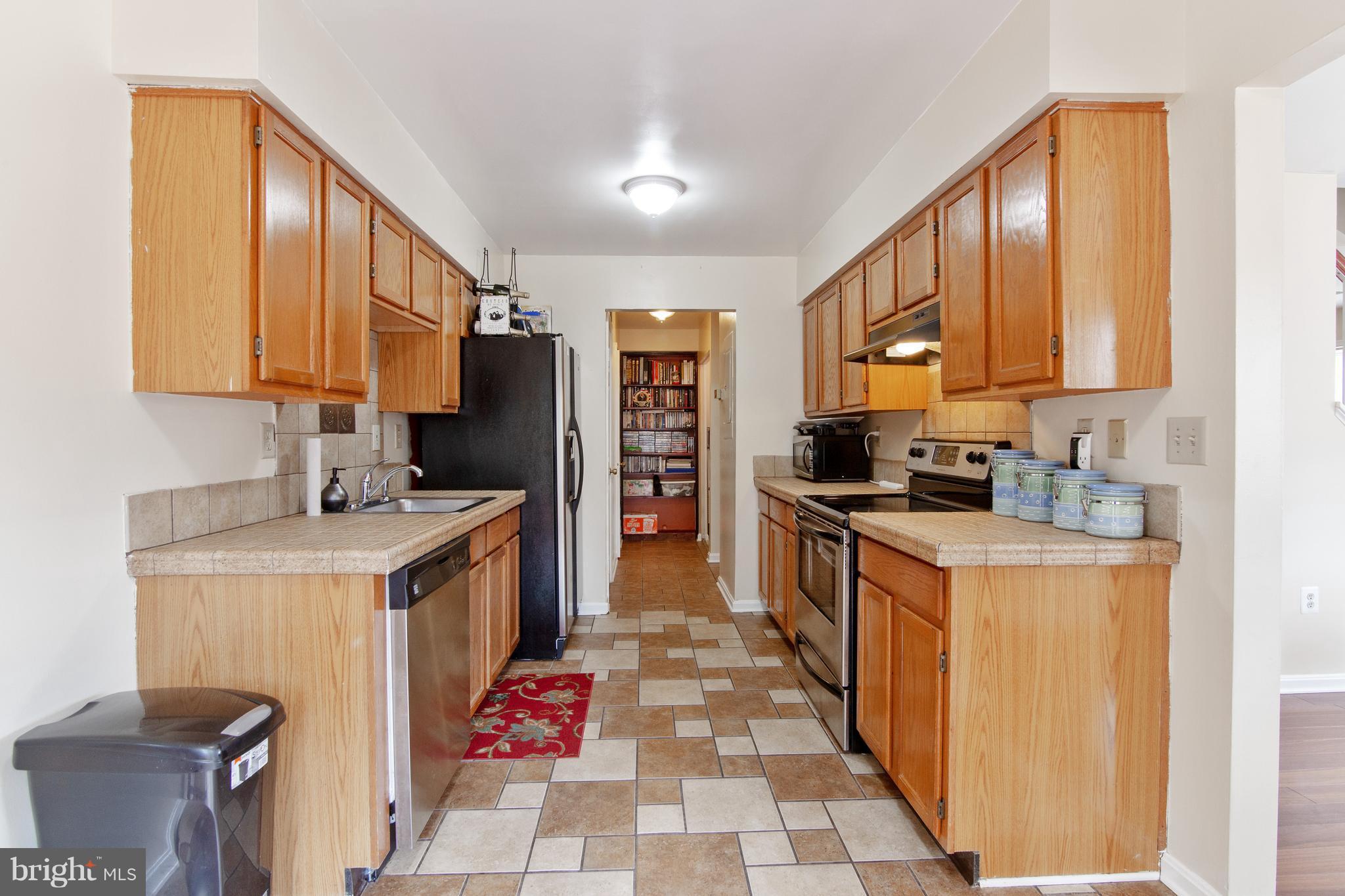 9304 Palmer Place, Unit 5 Laurel, MD 20708 - Photo 13 of 30 a kitchen with stainless steel appliances granite countertop a stove a sink and a refrigerator