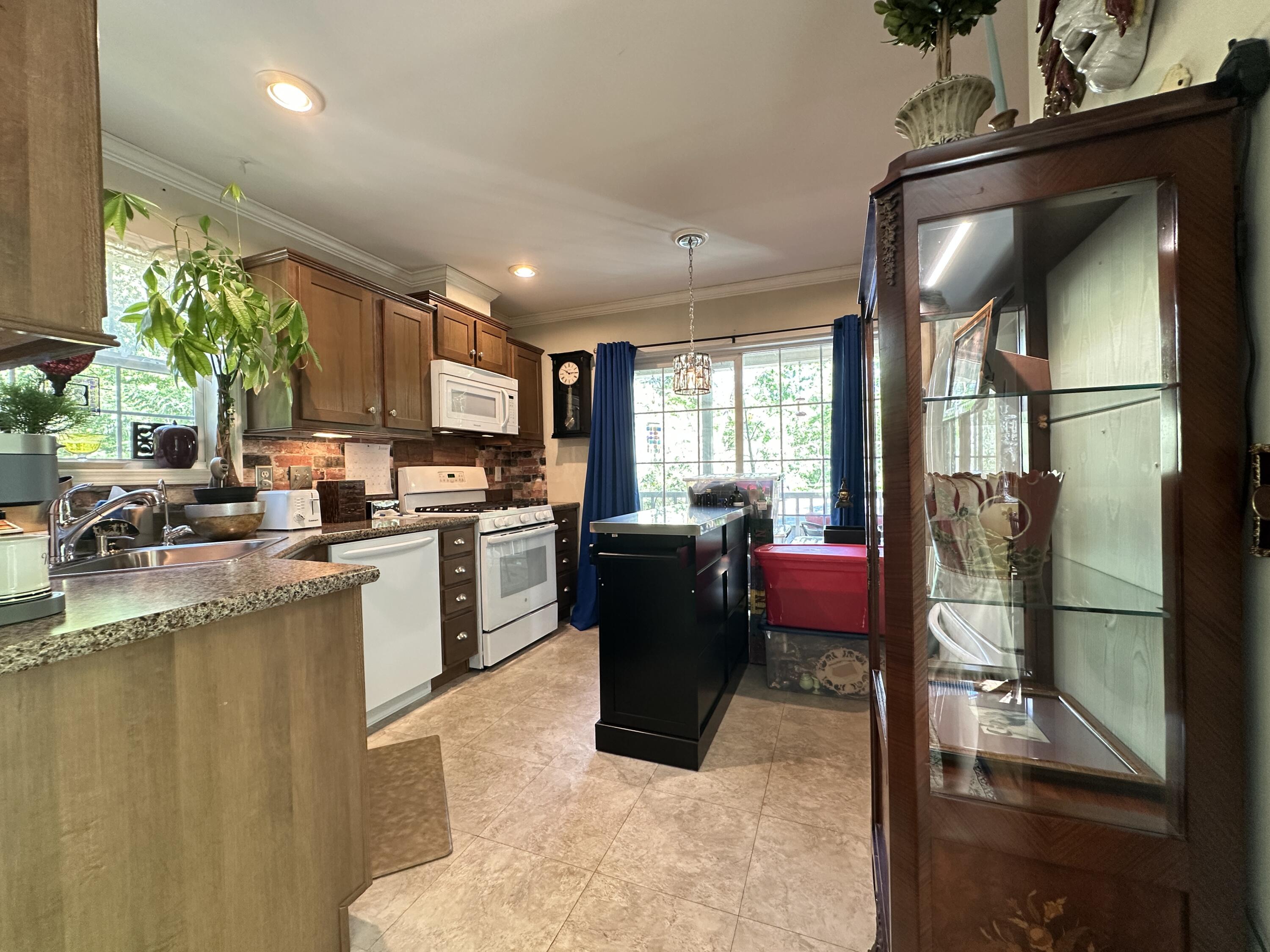 210 West Road, Unit E12 Wellfleet, MA 02667 - Photo 8 of 30 a kitchen with a refrigerator and a counter top space