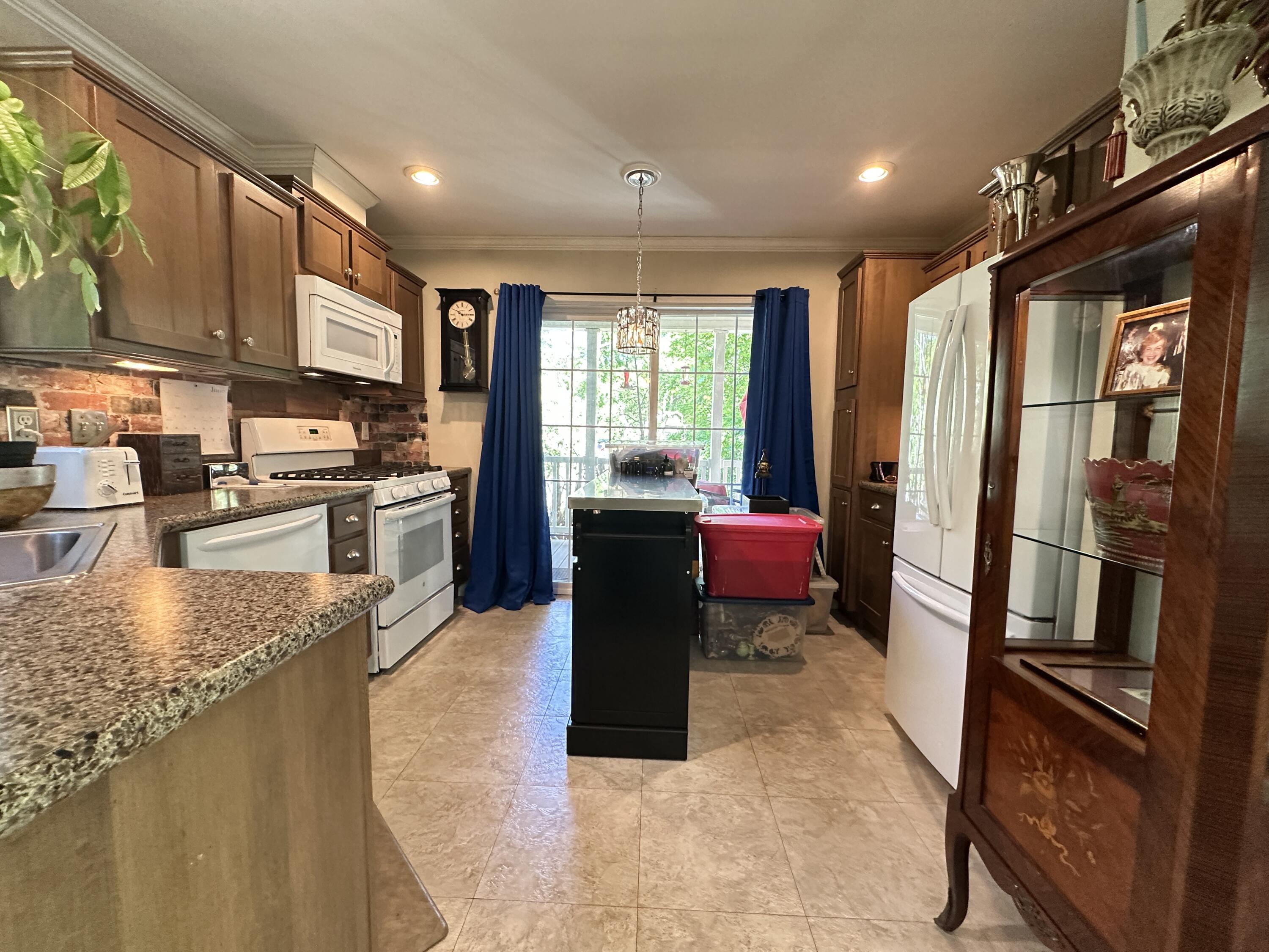210 West Road, Unit E12 Wellfleet, MA 02667 - Photo 9 of 30 a kitchen with stainless steel appliances granite countertop a refrigerator a stove top oven a sink and dishwasher