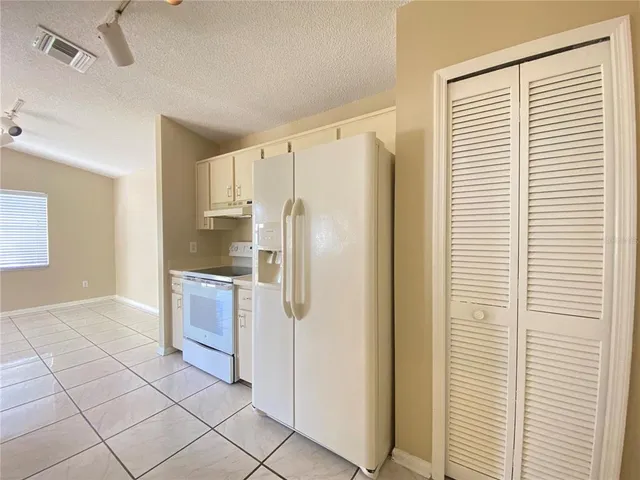 a kitchen with stainless steel appliances a refrigerator and a sink