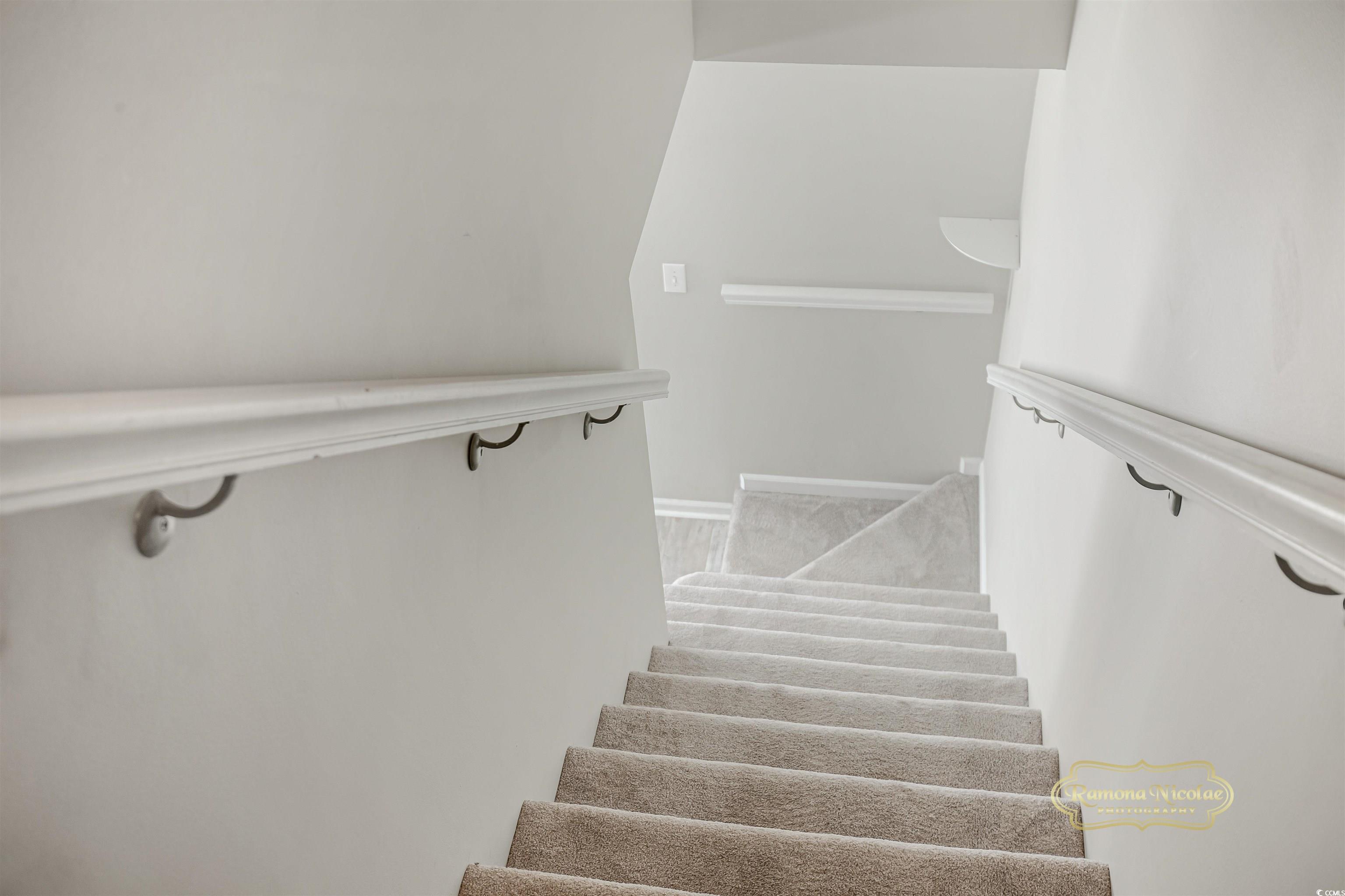 5161 Inlet Garden Court, Unit 8C Murrells Inlet, SC 29576 - Photo 20 of 31 Stairs with baseboards