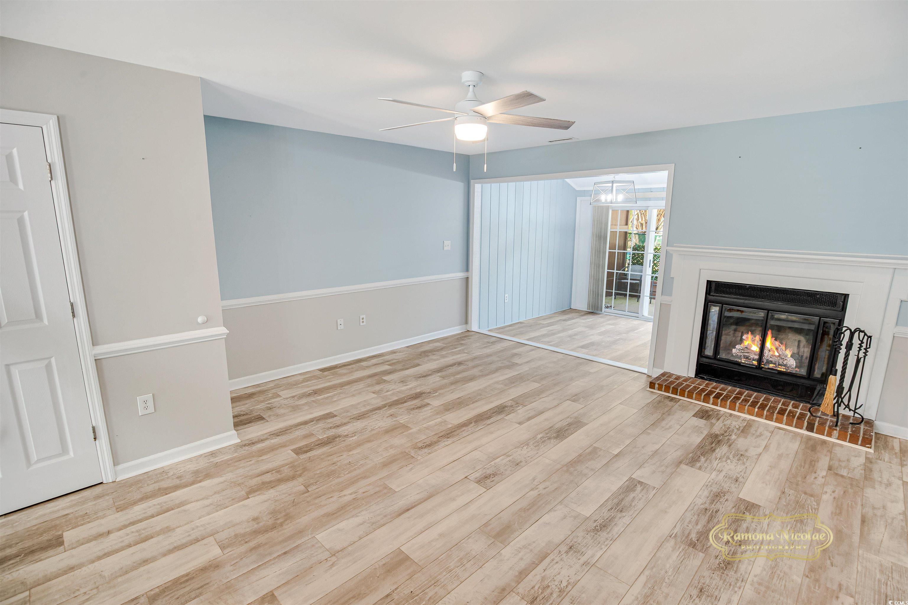 5161 Inlet Garden Court, Unit 8C Murrells Inlet, SC 29576 - Photo 8 of 31 Unfurnished living room featuring a brick fireplac